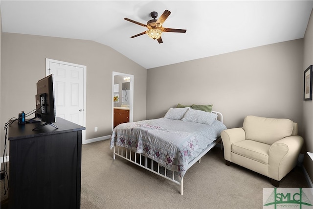 carpeted bedroom with ceiling fan, lofted ceiling, and ensuite bath