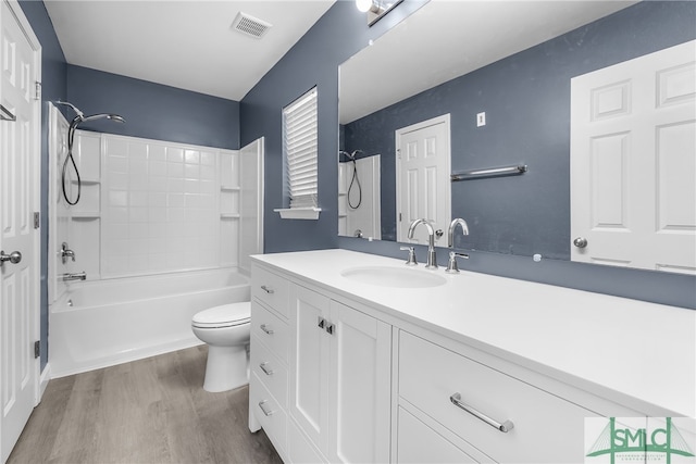 full bathroom with toilet, vanity, tub / shower combination, and hardwood / wood-style flooring