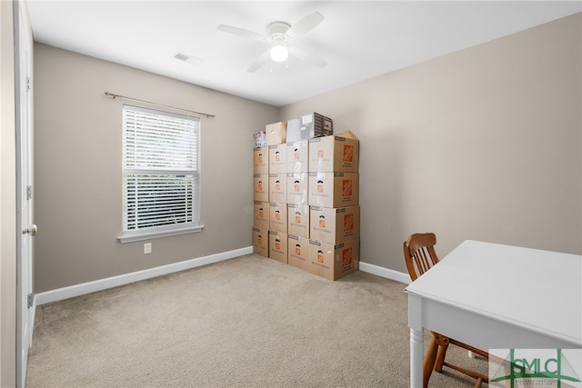 office space with ceiling fan and light colored carpet