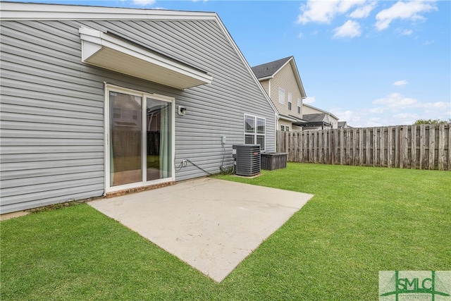 view of yard with central air condition unit and a patio