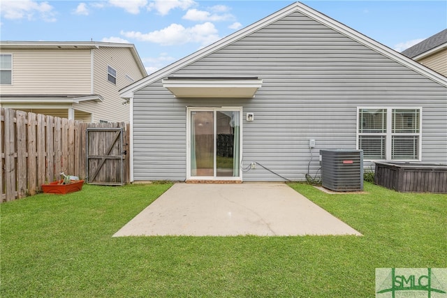 back of house featuring a lawn, a patio area, and cooling unit