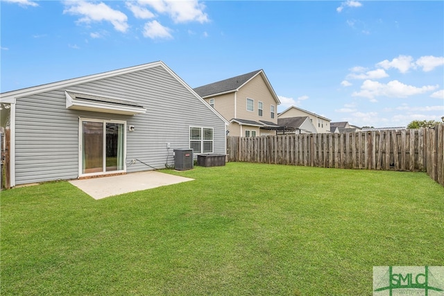 rear view of property featuring a yard, a patio, and cooling unit