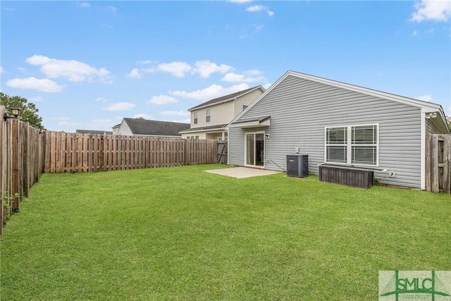 rear view of property with a lawn, cooling unit, and a patio