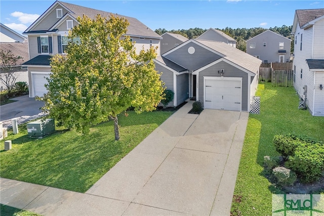 view of front of house with a garage and a front lawn