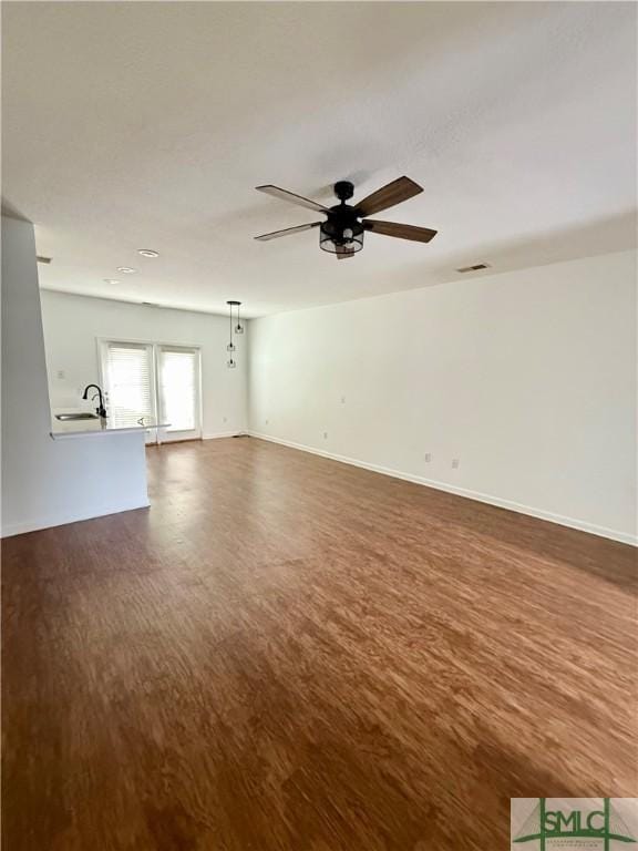 unfurnished room featuring ceiling fan and dark hardwood / wood-style flooring