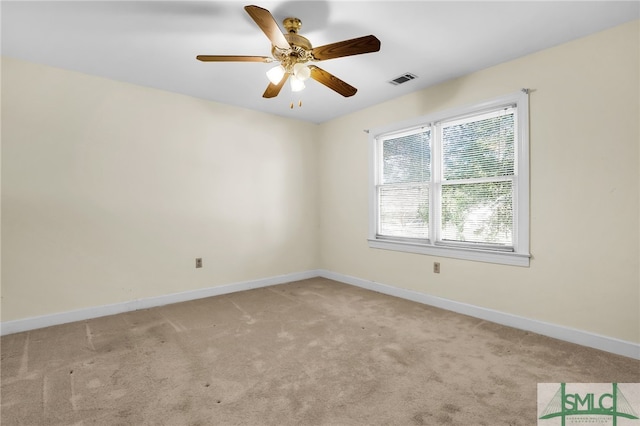 spare room featuring light carpet and ceiling fan