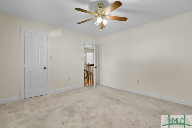 empty room with ceiling fan and light colored carpet