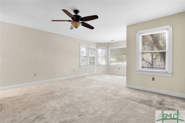 unfurnished living room featuring ceiling fan and light colored carpet