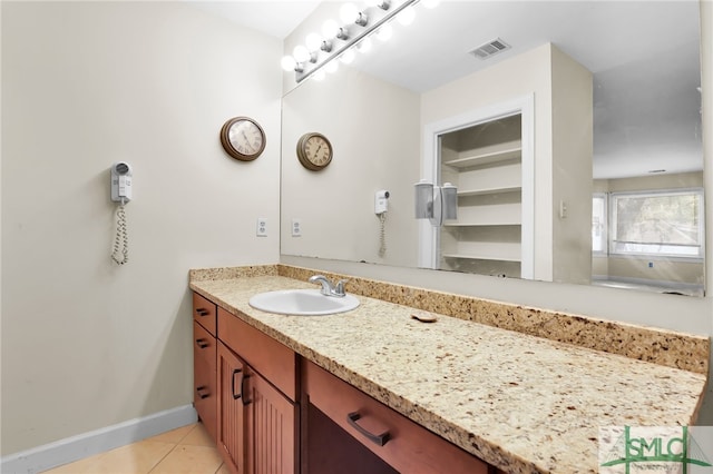 bathroom with tile patterned floors and vanity