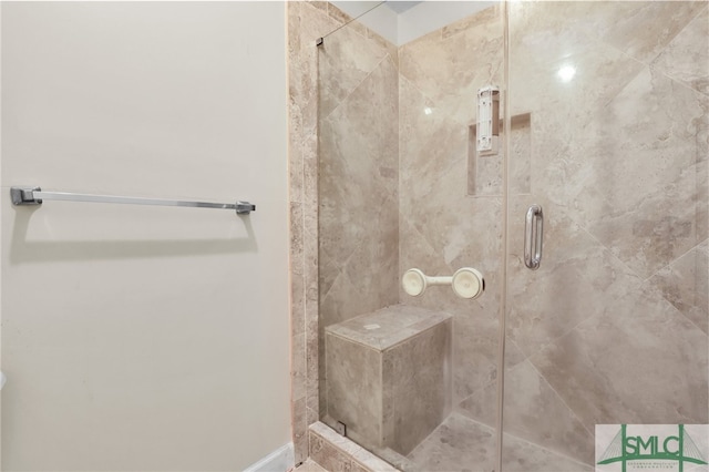 bathroom featuring a shower with shower door