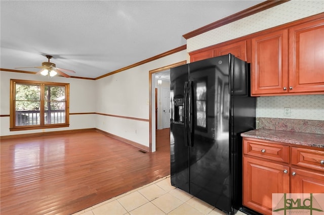 kitchen with ceiling fan, tasteful backsplash, black refrigerator with ice dispenser, light wood-type flooring, and ornamental molding