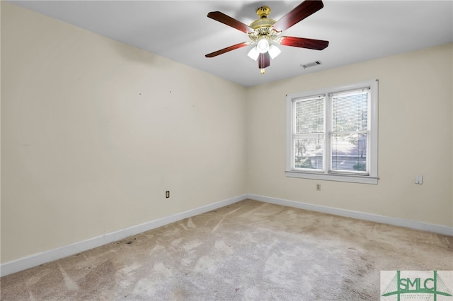 carpeted spare room with ceiling fan