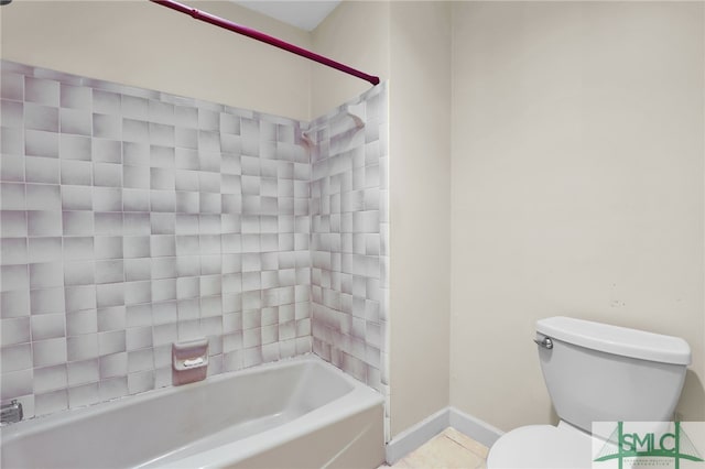 bathroom featuring tile patterned floors, tiled shower / bath combo, and toilet