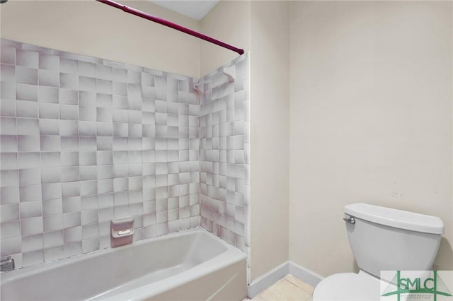 bathroom with tile patterned floors, bathtub / shower combination, toilet, and baseboards