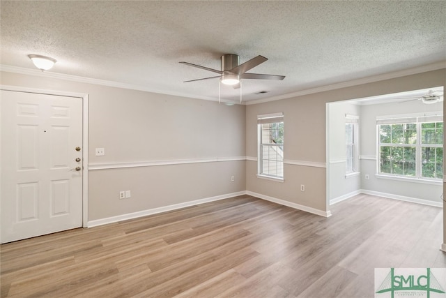 unfurnished room with a textured ceiling, light hardwood / wood-style floors, ceiling fan, and crown molding