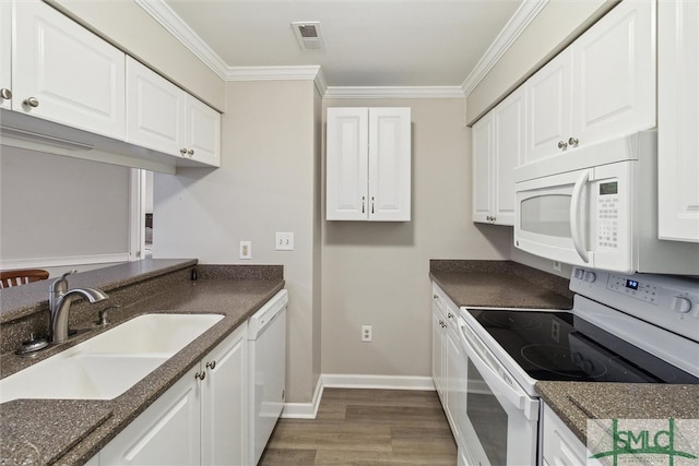 kitchen featuring white appliances, dark wood-type flooring, white cabinets, crown molding, and sink