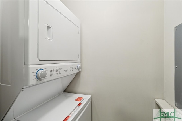 clothes washing area with stacked washer and dryer