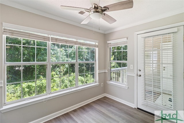 unfurnished sunroom with ceiling fan