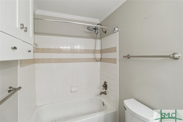 bathroom featuring tiled shower / bath combo, toilet, and ornamental molding