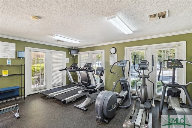 workout area with a textured ceiling and a wealth of natural light