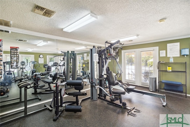 gym with ornamental molding and a textured ceiling