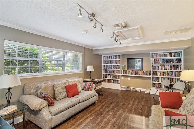 living room with dark hardwood / wood-style flooring, track lighting, a textured ceiling, and ornamental molding