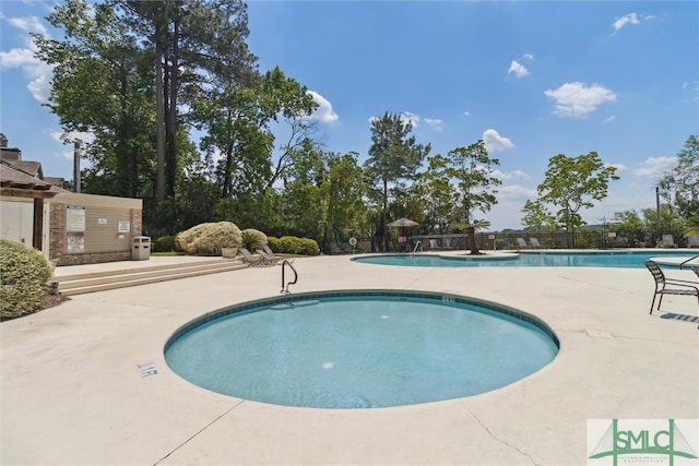 view of swimming pool with a patio area