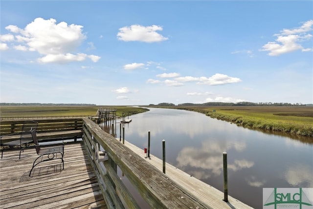 dock area featuring a water view and a rural view