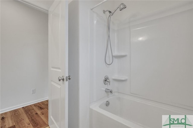 bathroom featuring shower / bathing tub combination and hardwood / wood-style flooring