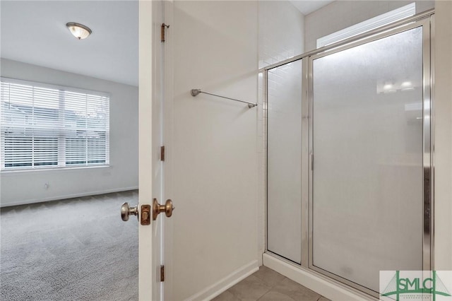 bathroom with a shower with door