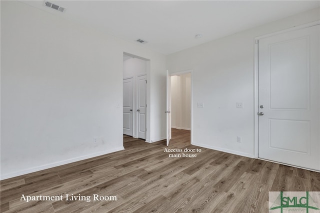 unfurnished room with light hardwood / wood-style flooring