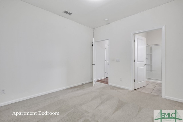 unfurnished bedroom featuring light colored carpet