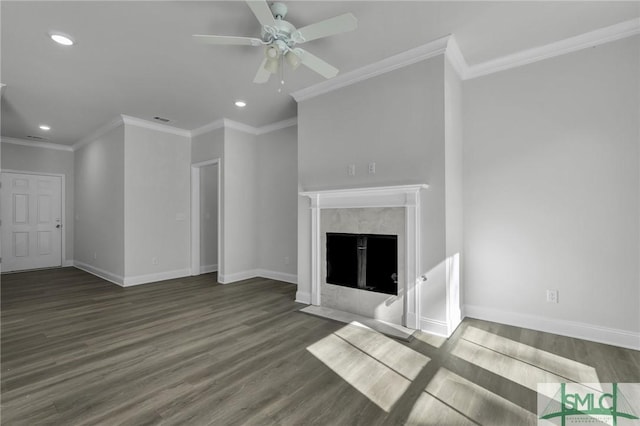 unfurnished living room featuring a premium fireplace, ornamental molding, dark wood-type flooring, and ceiling fan