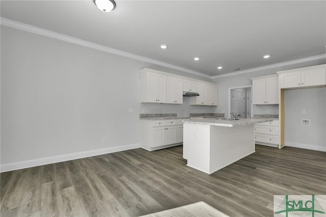 kitchen with a kitchen island with sink, crown molding, dark hardwood / wood-style flooring, and white cabinets