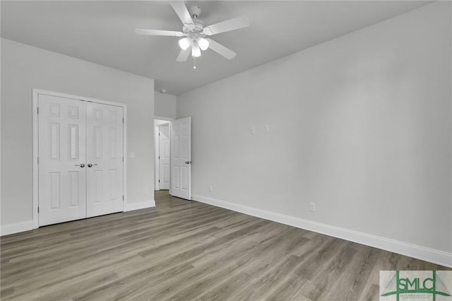 unfurnished bedroom with ceiling fan, light hardwood / wood-style floors, and a closet