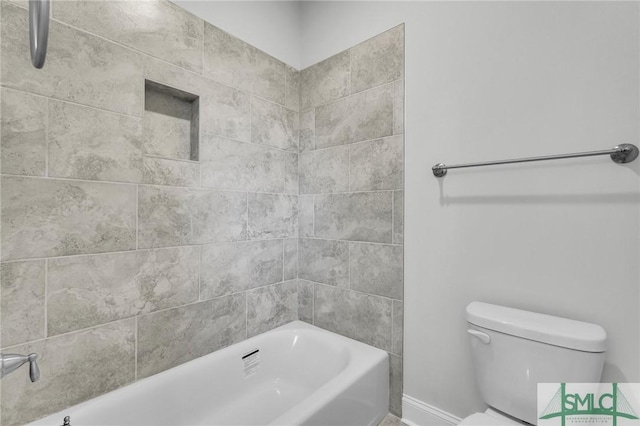 bathroom with tiled shower / bath combo and toilet