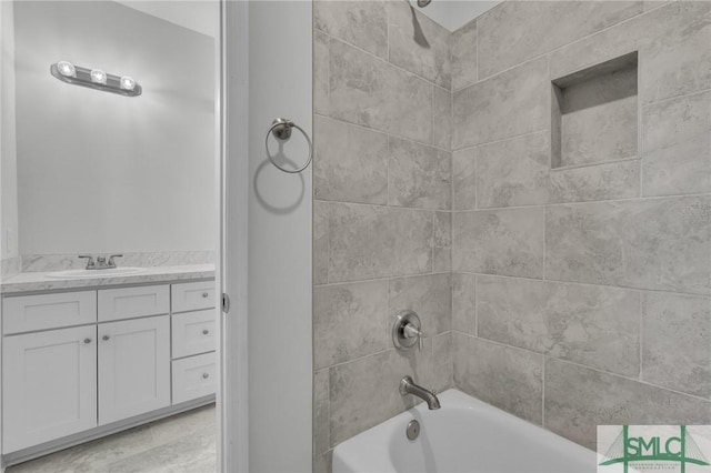 bathroom featuring vanity and tiled shower / bath combo