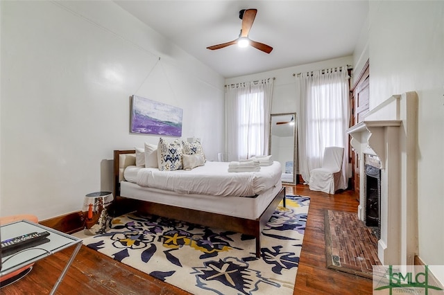 bedroom with ceiling fan and dark hardwood / wood-style flooring