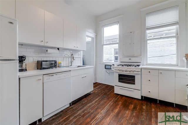 kitchen with backsplash, white appliances, sink, dark hardwood / wood-style floors, and white cabinetry