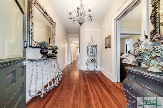 hallway with a chandelier and wood-type flooring