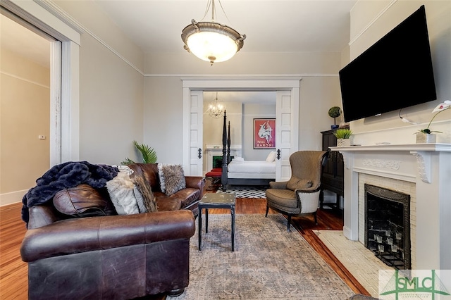 living room with hardwood / wood-style floors and a notable chandelier