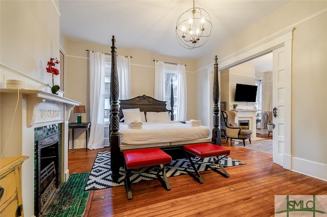 bedroom with wood-type flooring and a notable chandelier