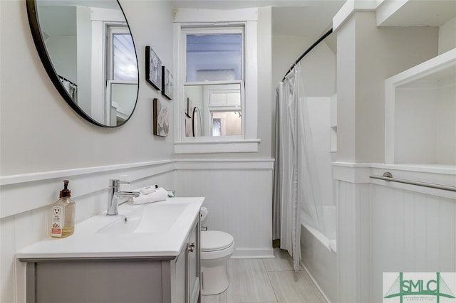 full bathroom with shower / bath combo, vanity, and toilet