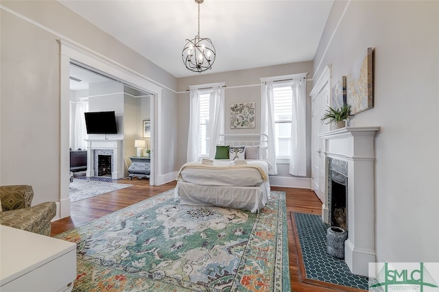 bedroom with a chandelier and dark hardwood / wood-style floors