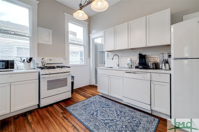 kitchen with dark hardwood / wood-style flooring, white appliances, white cabinetry, and sink