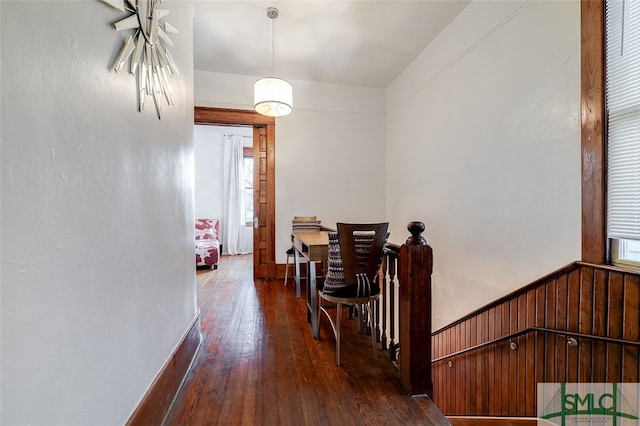 hallway with dark hardwood / wood-style flooring