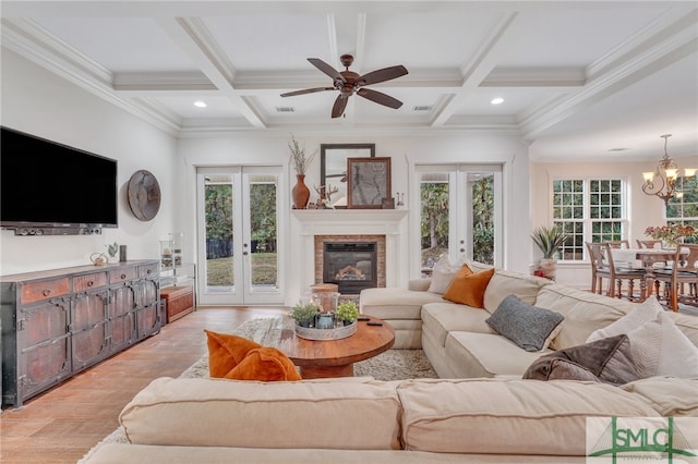 living room with beamed ceiling, french doors, light hardwood / wood-style flooring, and coffered ceiling