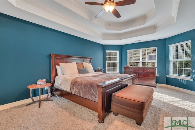 bedroom with light carpet, a raised ceiling, ceiling fan, and crown molding