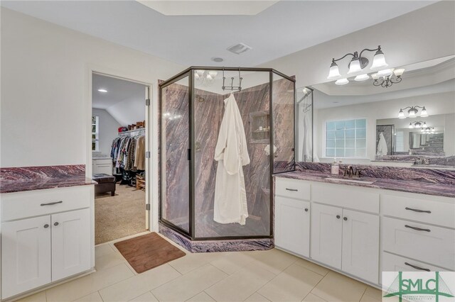 bathroom featuring vanity, tile patterned floors, and a shower with door