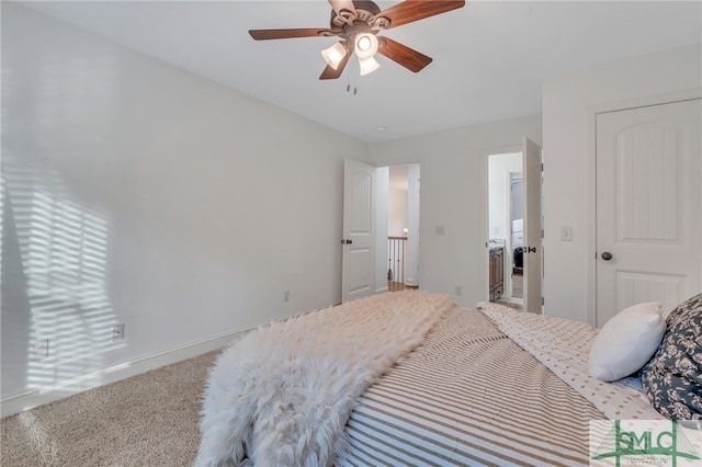 carpeted bedroom with ceiling fan and ensuite bathroom